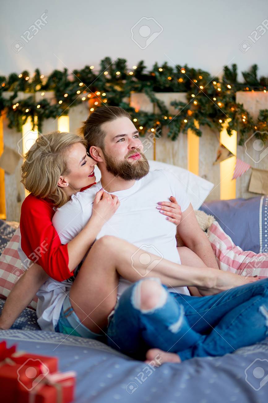 若い幸せなカップルは、ハグでソファに座って、タブレットを見ての写真素材・画像素材 Image 94420190